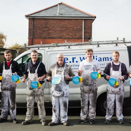 ER Williams team group photo with Living Wage bunting