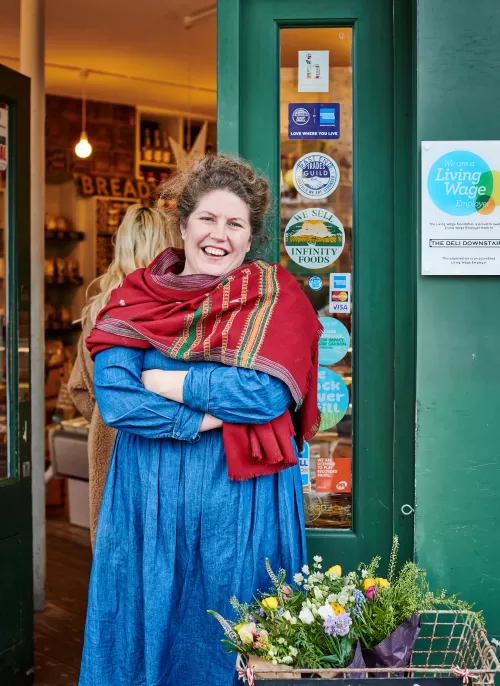 The Deli Downstairs owner standing outside shop