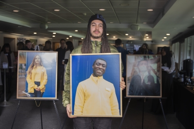 A man holds a portrait of an IKEA worker.