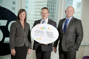 Two men and 1 women with recognised service provider sign