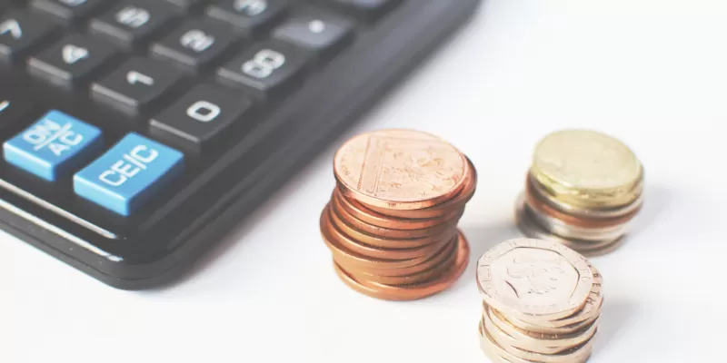 calculator and coin stack